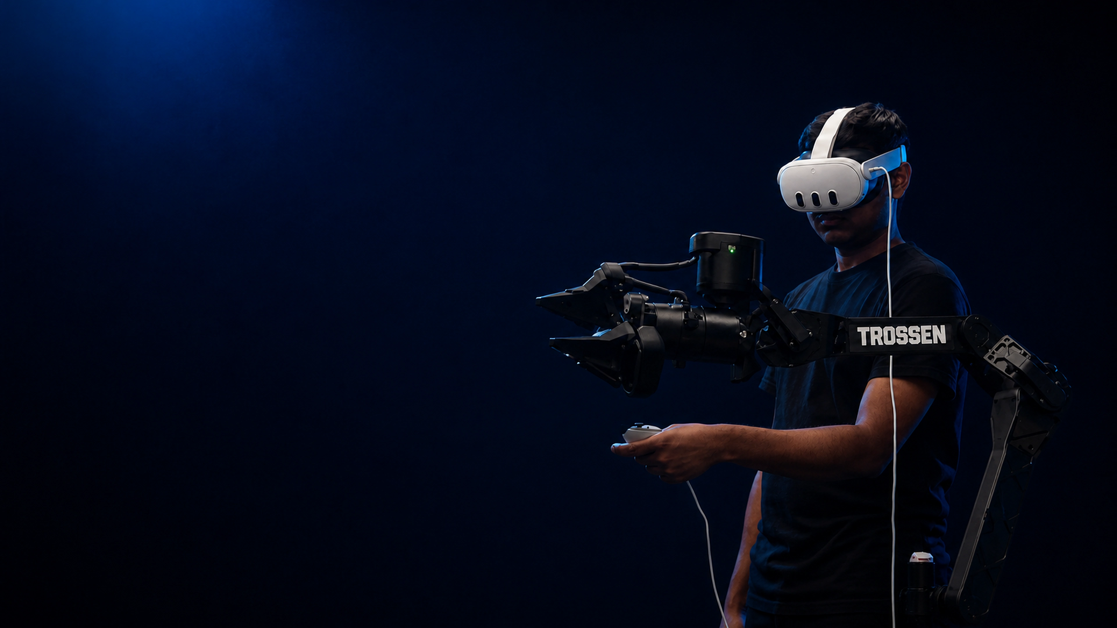 Apurv wearing a Meta Quest headset while operating a robotic arm in the lab